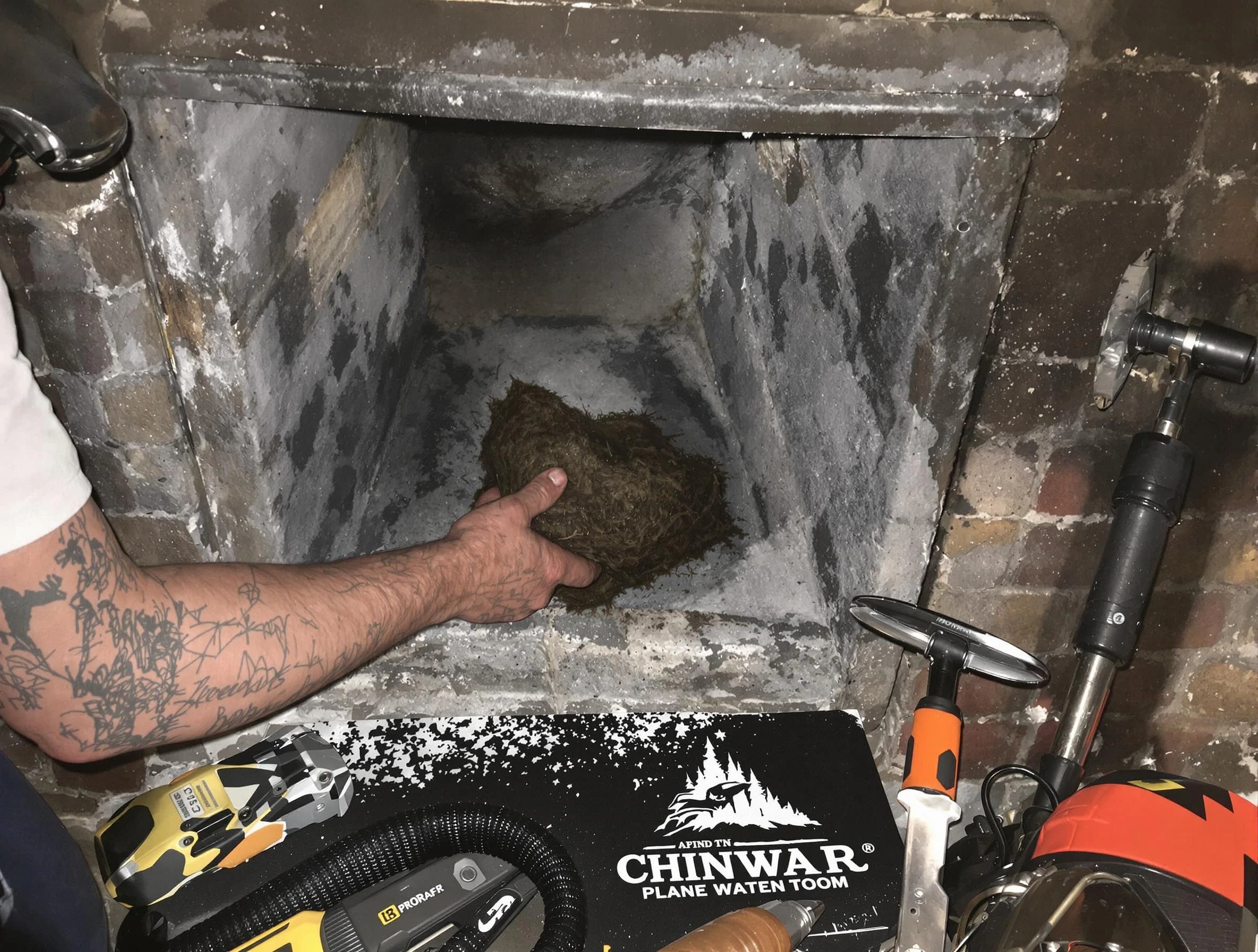 Newnan Chimney Sweep safely removing debris and screening chimney in Newnan, GA